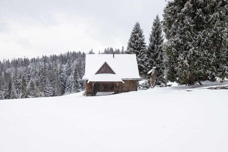 Cottage surrounded by snow in winter